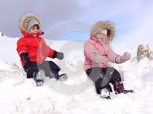 Twin babies playing in the snow