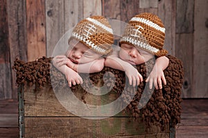 Twin Baby Boys Wearing Football Shaped Hats photo