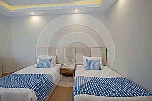 Twin beds in suite of a luxury hotel room