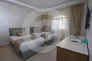 Twin beds in suite of a luxury hotel room