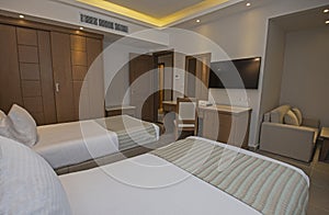 Twin beds in suite of a luxury hotel room