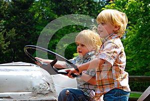 Twin boys driving tractor