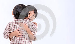 Twin boys hugging  on white background. Portrait of little son hugging brother or friend. I missing you. Full length happy boy emb