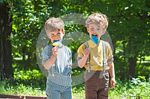 Twin boys with lollipops in hand