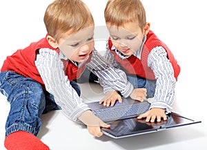 Twin brothers fighting for laptop