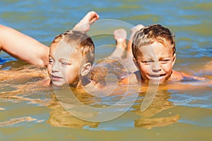 Twin brothers learn to swim