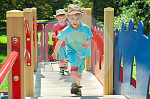 Twin brothers play catch-up on the playground