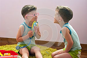 Twin brothers play in doctor