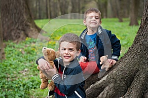 Twin brothers play in the forest