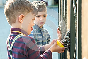 Twin brothers play with sprayer