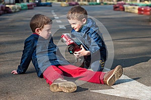 Twin brothers play with a toy car