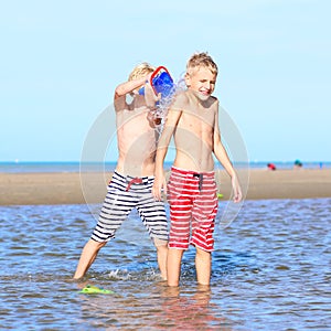 Twin brothers playing on the beach