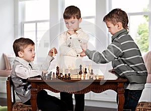 Twin brothers playing chess game