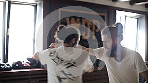 Twin brothers practice in Chinese martial arts in the training hall