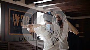 Twin brothers practice in Chinese martial arts in the training hall