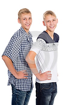 Twin brothers standing on white