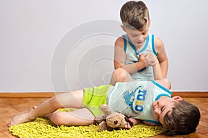 Twin brothers struggle on the floor