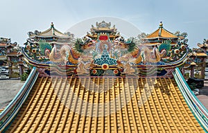 Twin Chinese dragons sculpture decorate on chinese-style temple roof