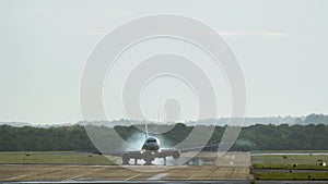 Twin engine commercial airplane landing in the airport with strong crosswind