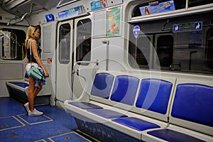 A twin-engine turbojet aircraft AN-148One girl in an empty metro car. At a later time in the subway few passengers