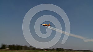 Twin-engined plane flying fast over airfield