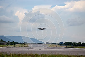 Twin engines propeller aircraft take off from runway and climb w