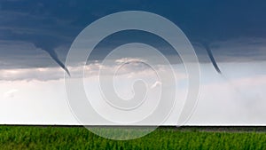 Twin funnel clouds from a pair of landspout tornadoes