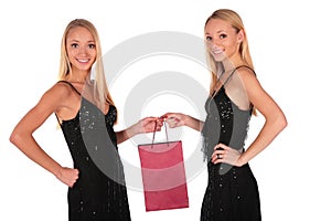 Twin girls holding small bag