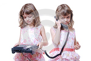 Twin girls with phone