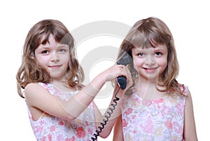 Twin girls with phone