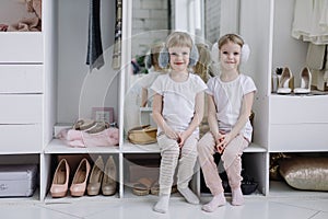 Twin Girls Try On Things in Their Mother's Modern Dressing Room.
