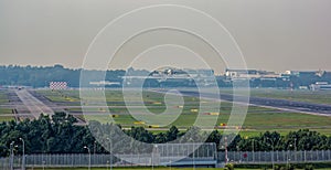 Twin jet engine airplane landing on Changi airport runway