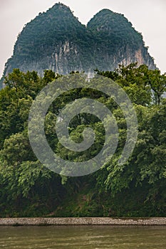 Twin karst mountains towering above Li River in Guilin, China