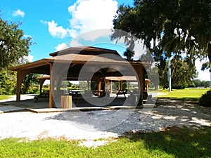 Twin Lakes Park in Sarasota Florida under a bright sunny blue sky with white fluffy clouds a lake and trees