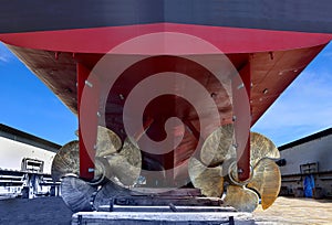 Twin Propeller Close up and Repair Cargo ship in floating dry dock.