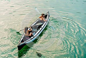 Twin sisters in a Canoe on the river in Ada Bojana, Montenegro