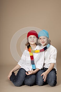 Twin sisters with caps and scarf