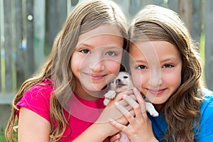 Twin sisters and puppy pet dog chihuahua playing