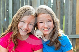 Twin sisters and puppy pet dog chihuahua playing