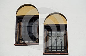 Twin windows on white facade