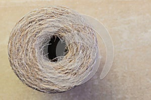 Twine rope jute linen in bobbins skeins close-up on a vintage background with copy space, household goods, production of rope