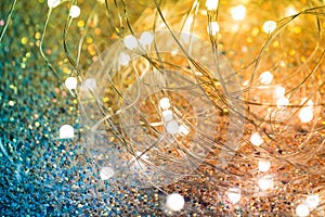 Twinkling Christmas lights on a shiny background. Yellow-green background with LEDs on a wire