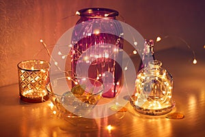 Twinkling lights in the interior, festive garlands with glass vases, home decor