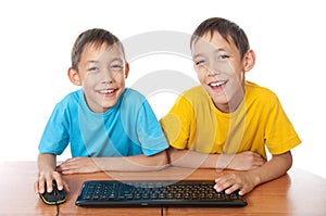 Twins with computer mouse and keyboard