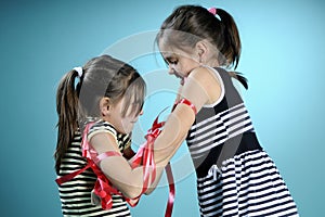 Twins exercising with red accessory