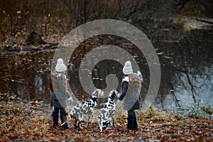 Twins girls portrait Dalmatian dogs