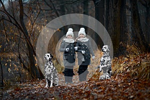 Twins girls portrait Dalmatian dogs