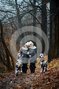 Twins girls portrait Dalmatian dogs