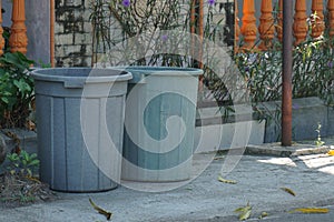 Twins of Plastic Grey Dustbin outside the gate