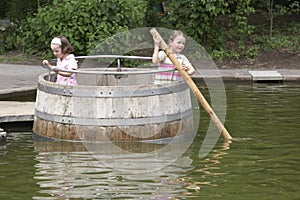 Twins playing in a barrel 04